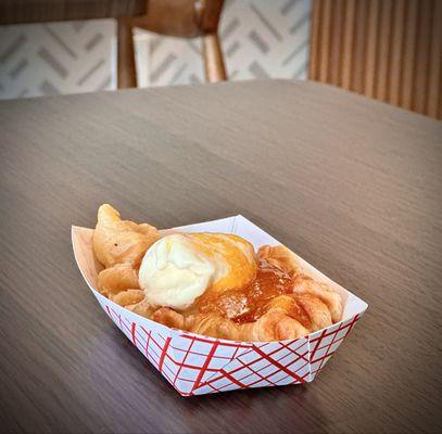 Croffle with mango topping and a scoop of ice cream.