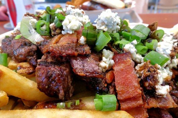Loaded steak fries with sliced NY steak and balsamic reduction sauce