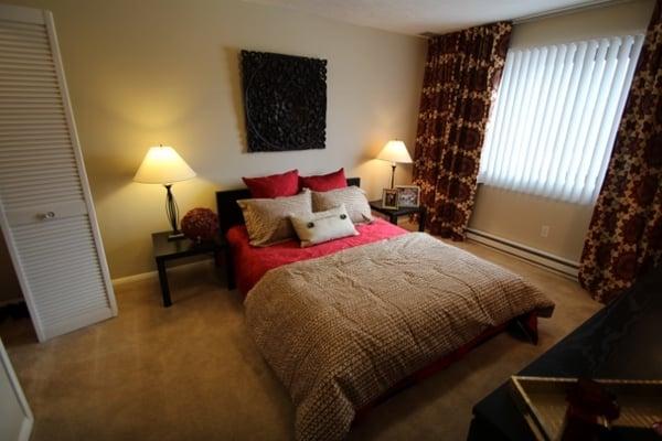 This master bedroom is showing a queen sized bed, two night stands and a dresser. Tons of space!