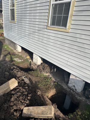 Pushed pilings under existing pier and continuous footing