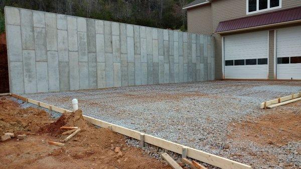 Poured in place concrete retaining wall.