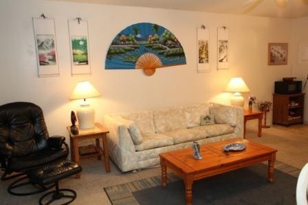 Living room in condo. Has free wifi, a patio w/ table and chairs, big screen tv, dvd's & dvd player. It has a pull out couch that sleeps 2.