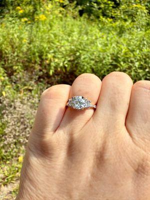 Three stone custom engagement ring! Round solitaire with Cadillac side stones set in platinum head with 18k yellow gold pave band!