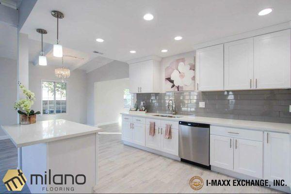 Our IM-053, "Moonlight" laminate floor with Cambridge Cabinetry Shaker White. Top drawers were replaced with custom flat panel drawers.