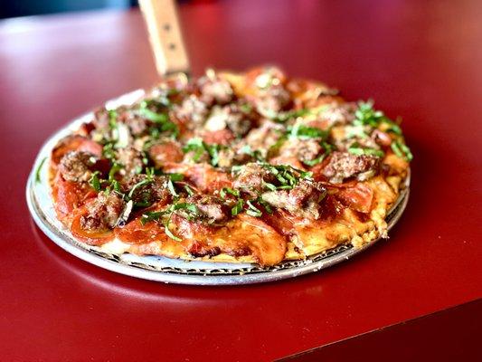 Sausage, pepperoni pizza with vodka sauce. Topped with fresh grated Parmesan and basil