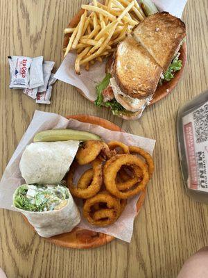 Top: Turkey Club , side Shoe String fries Bottom : Caesar salad Wrap , side Onion rings
