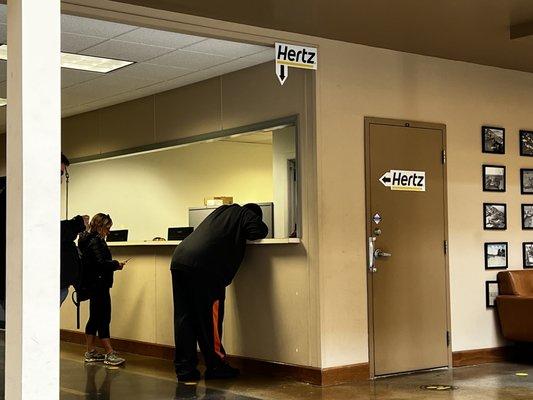 These two signs point to where Hertz is located.