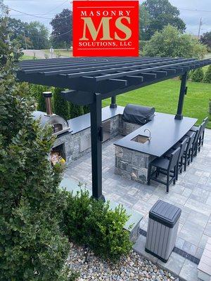 Newly installed patio with outdoor kitchen and pergola. Fully equipped with state of the art grill, sink, fridge, garbage, and pizza oven!