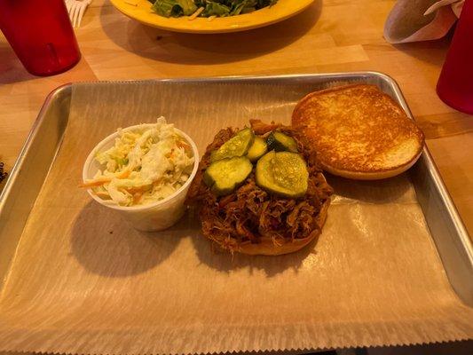 Pulled pork sandwich with a side of slaw