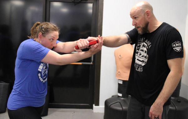 A high level student working on a defense against a handgun threat.