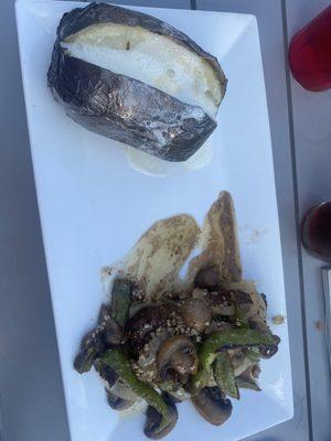 Huge baked potato , flat iron steak with onions, peppers, mushrooms
