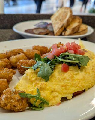 BLT Omelette with Parmesan tots, sourdough toast, and sausage patties