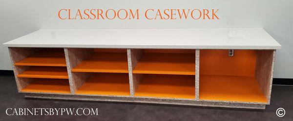 Color inspires creativity. Base Cabinet with bright orange shelves is perfect for classroom projects.