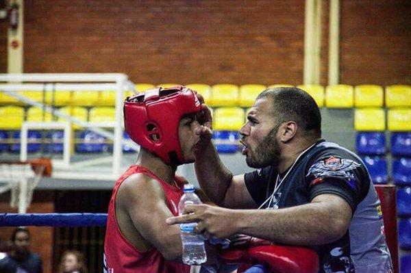 Our boxing teacher coach one of our students at the competition.