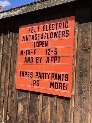 Outdoor sign with hours