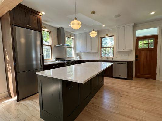 Beautiful two-toned kitchen custom flush-inset cabinets.  Painted Maple Colonial White on top and Natural Black Walnut on base.