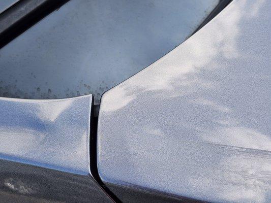 Dent sticking up from under. My guess is they closed something in it and scratched it getting it out.