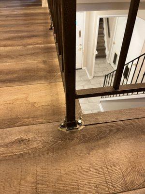 Unfinished/ messy look. They left without my banister being secured and they came back a week later but then this is what I'm left with