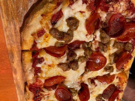 Flat bread pizza with pepperoni and sausage