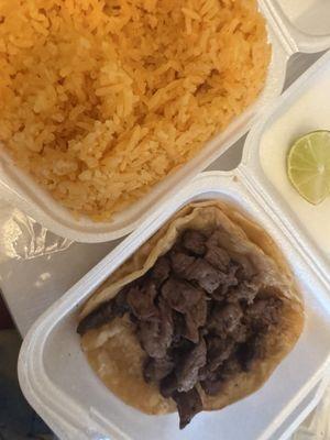 Asada taco plain with a side of rice.