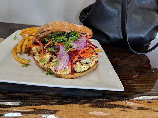 Peruvian bean and sweet pepper spread, with roasted cauliflower, shredded beets and carrots, micro celery, and a delicious pistachio pesto.