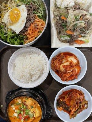 Bibim Bap (top left), Japchae Bap (top right), and Soon Du Boo Bak Ban with rice and kimchi (bottom)