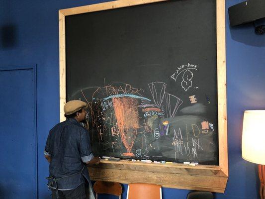 Chalk board built into the wall at the back of the shop