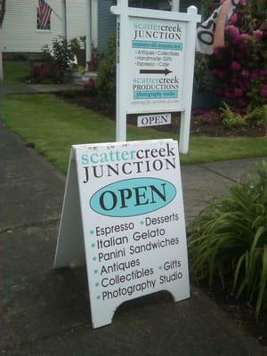 The signs leading you down the garden path the the shop behind