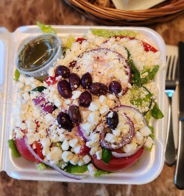 The best Greek salad around topped with loads of feta cheese, greek olives and homemade dressing.