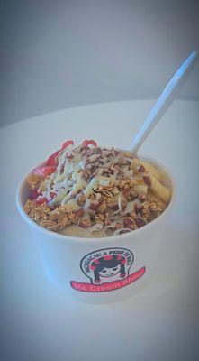 a su bowl with strawberry, banana, granola, coconut, condensed milk drizzle!