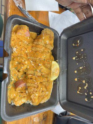 Seafood dirty rice with spicy sauce and fried catfish