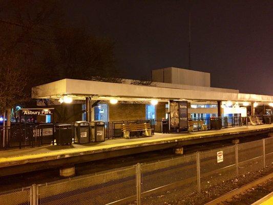 Train tracks and station at night.