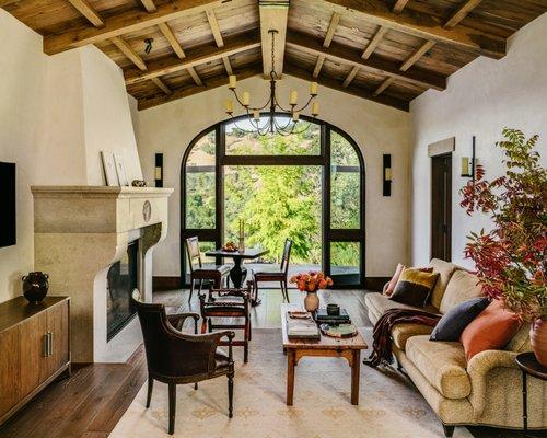 Inviting modern tuscan cottage with large arched doors and antique heavy timber ceiling.
