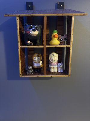 A shelf I bought here with various figurines in each compartment (the two salt and pepper shakers I also bought here)