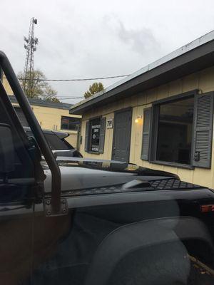 Small building with sign on window.