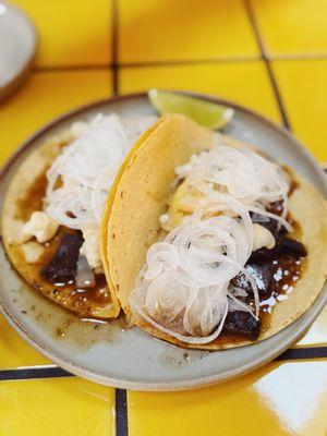 beef cheek taco - guajillo jus, coriander, escabeche, scallion bulb