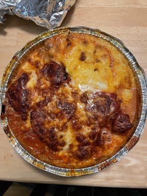 Meatloaf parmesan, smothered in toasted cheese on a bed of parmesan mashed potatoes with a delectable tomato sauce. Chef's kiss!