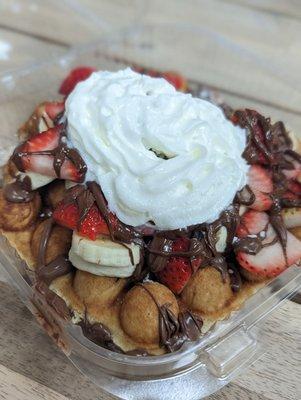 Bubble waffle with nutella, strawberry, bananas and whip cre