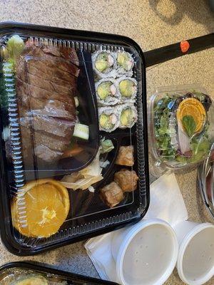 Beef teriyaki Bento Box done medium rare with soup, rice and salad.