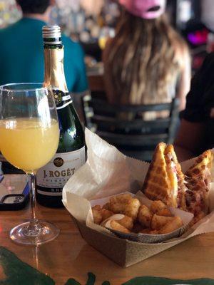 Breakfast sandwich with mimosa