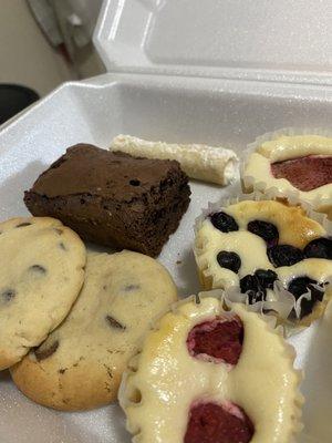 Mini cannoli, brownie, chocolate chip cookies, mini strawberry cheesecake, mini blueberry cheesecake, mini raspberry cheesecake
