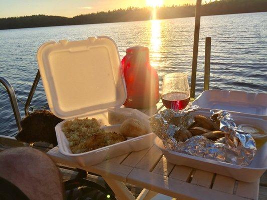 Baked stuffed haddock, steamed clams, got it to go and sitting on the dock