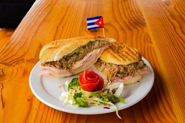 At Azúcar Cuban Cuisine, every bite is an invitation to enjoy the authentic flavors of Cuba. Our delicious Cuban sandwich, prepared with fre