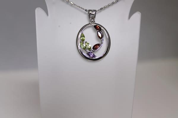 Check out the peridot, amethyst and garnet stone in nice cut, set in sterling silver.