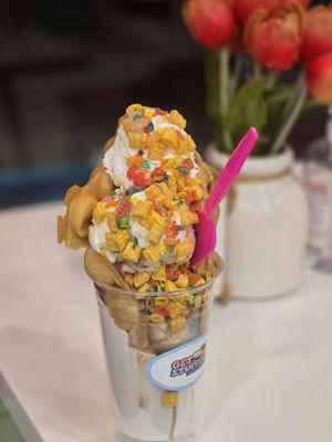 Bubble waffle cone with banana pudding ice cream, Captain Crunch and Fruity Pebbles cereal toppings.