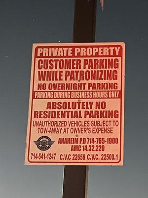 The sign where my car got towed while shopping in the plaza