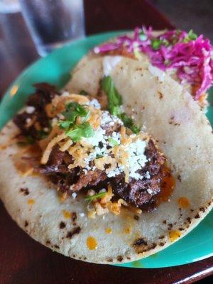 Barbacoa taco. Good flavor, not that bold or spicy though, and can see grease already pooling, squeezing it out there was a lot.