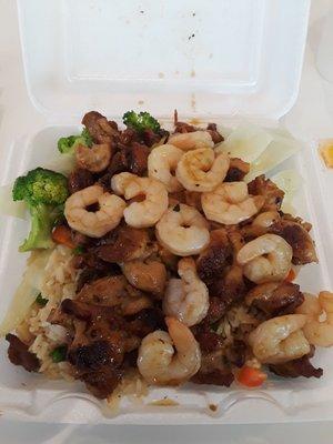 Chicken and shrimp combo with vegetables and fried rice.