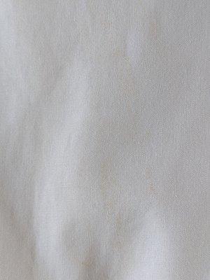 Brown stain on a white dress shirt that's not cleaned at all even though I paid good money for them to do so. Scam alert.