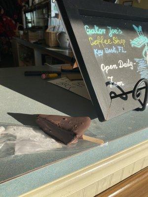 Frozen, chocolate covered key lime pie on a stick